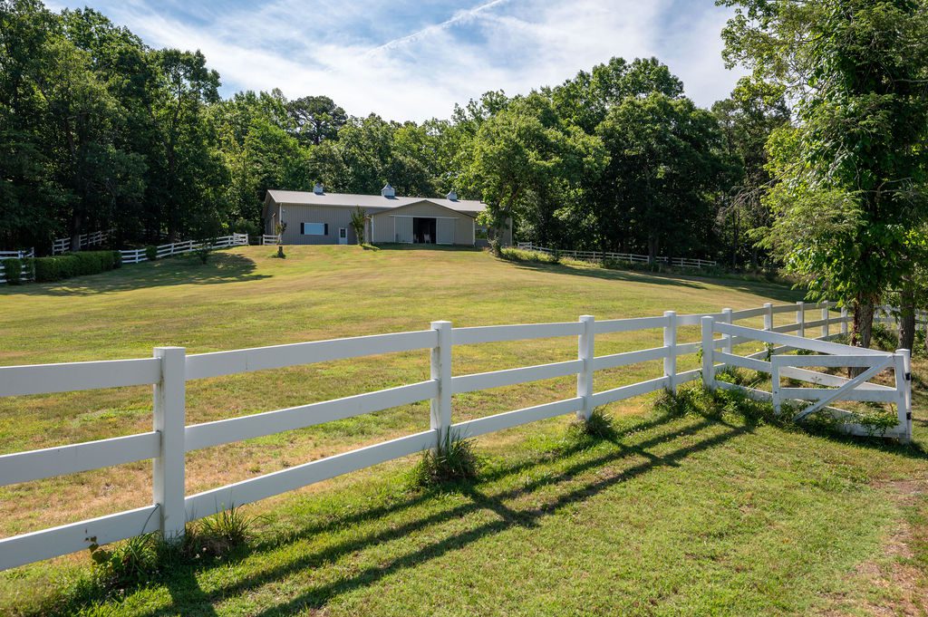 Historic farm for sale with horse barn, stables, riding arena, and fenced pastures in Albemarle County